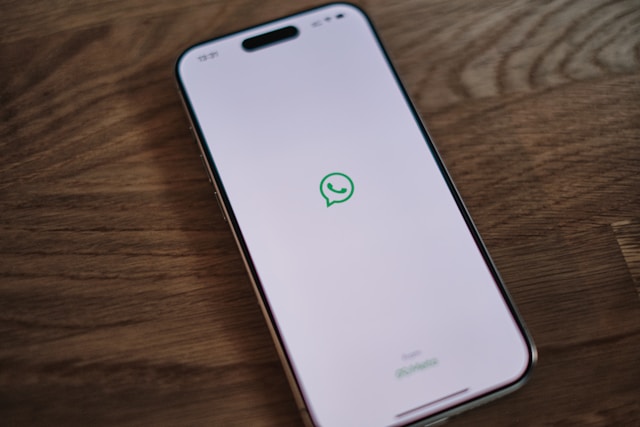 Smartphone showing a WhatsApp conversation with several long voice messages